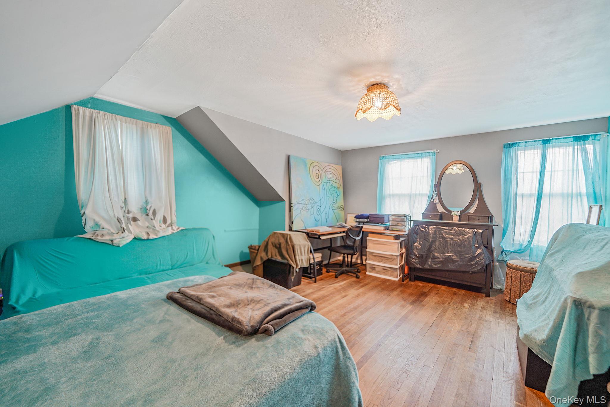 7 Rugby Road Westbury, NY 11590 - Photo 29 of 46 Bedroom with hardwood / wood-style flooring and vaulted ceiling