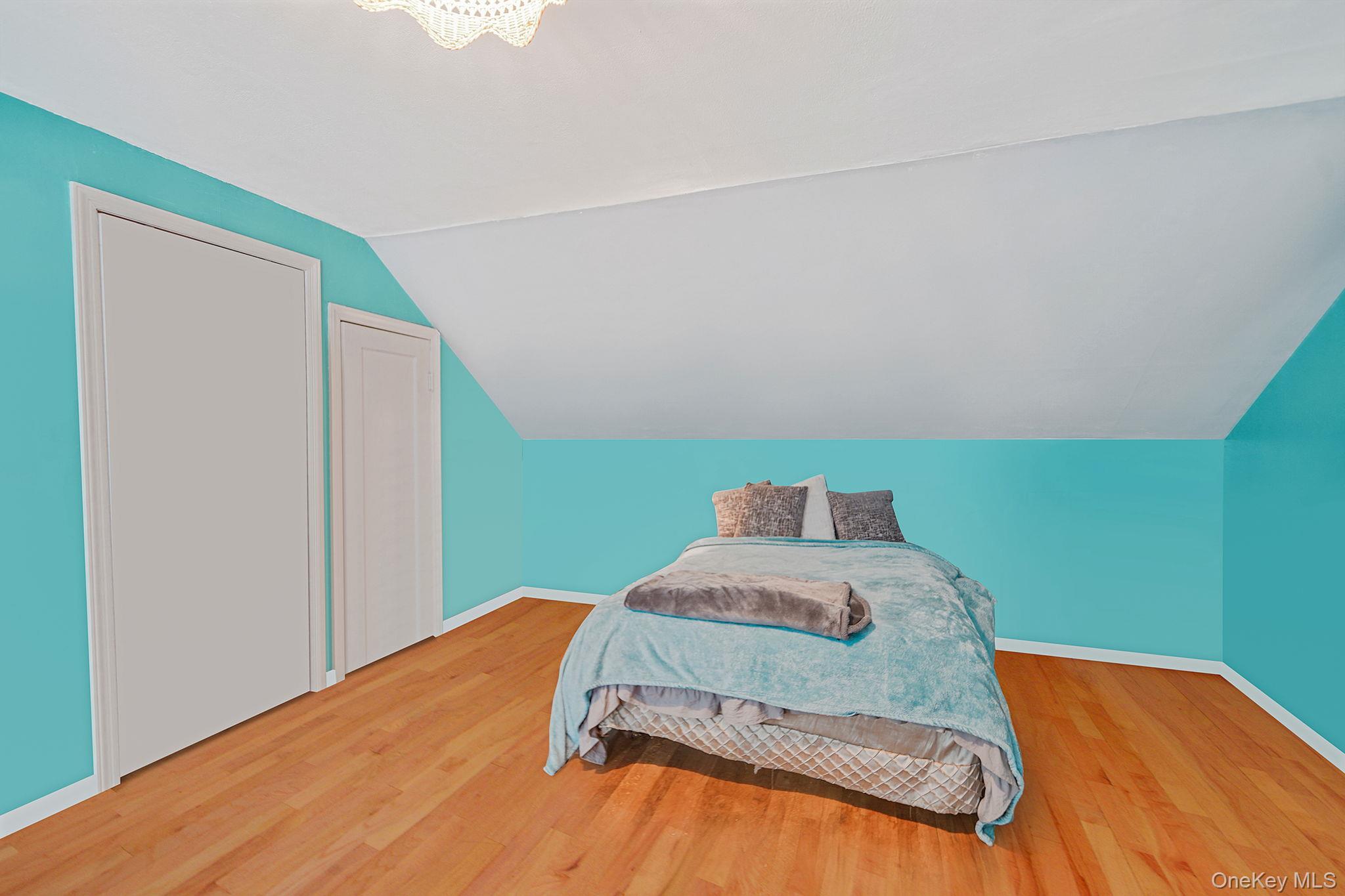7 Rugby Road Westbury, NY 11590 - Photo 30 of 46 Bedroom featuring wood finished floors and lofted ceiling
