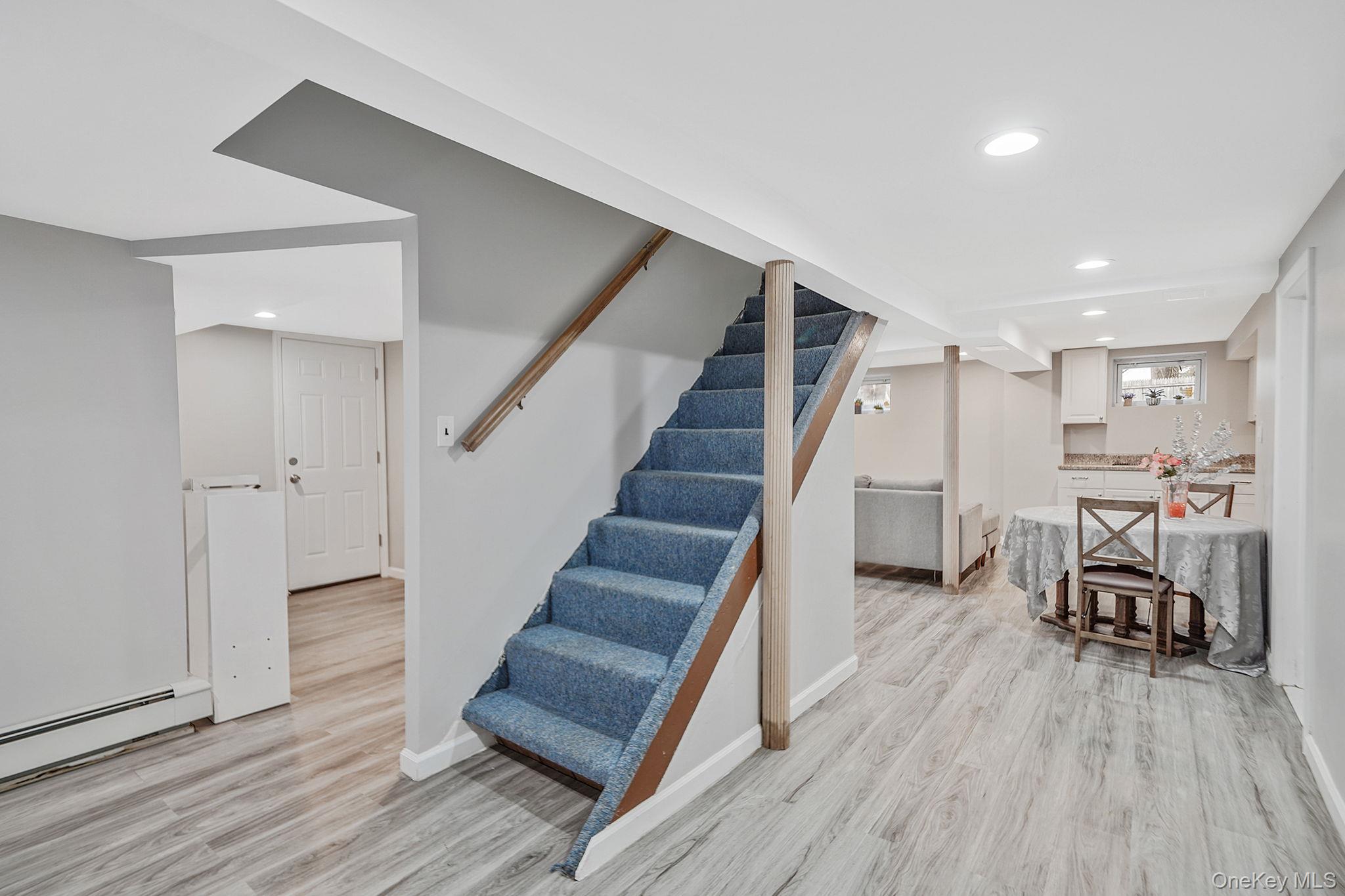 7 Rugby Road Westbury, NY 11590 - Photo 31 of 46 Finished basement featuring light wood-style flooring, stairs, and recessed lighting