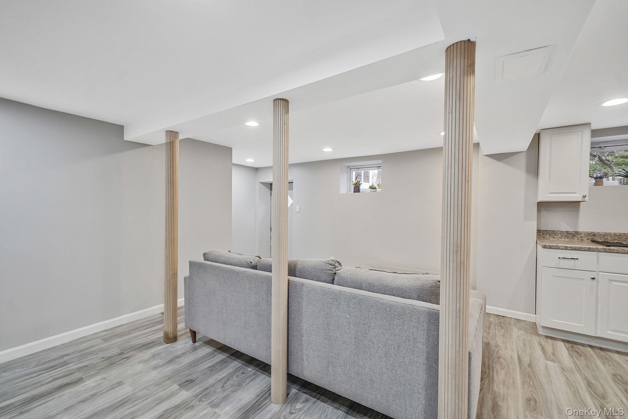 7 Rugby Road Westbury, NY 11590 - Photo 32 of 46 Living area with light wood-style flooring and recessed lighting