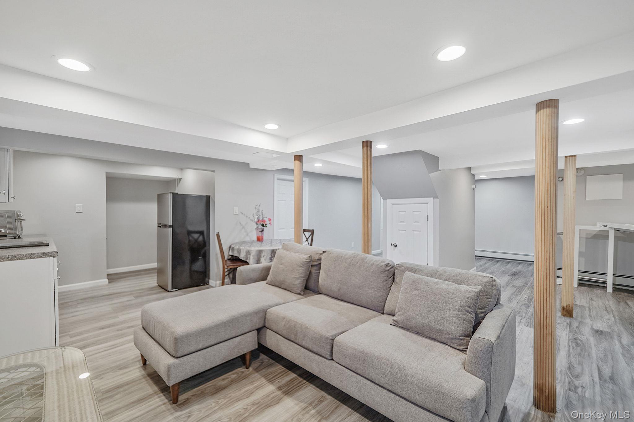 7 Rugby Road Westbury, NY 11590 - Photo 34 of 46 Living room with light wood-style floors, recessed lighting, and a baseboard heating unit