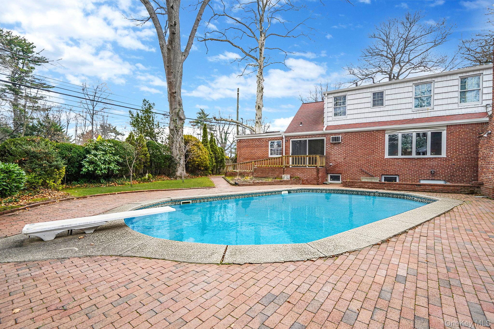 7 Rugby Road Westbury, NY 11590 - Photo 42 of 46 Swimming pool with a diving board and a patio