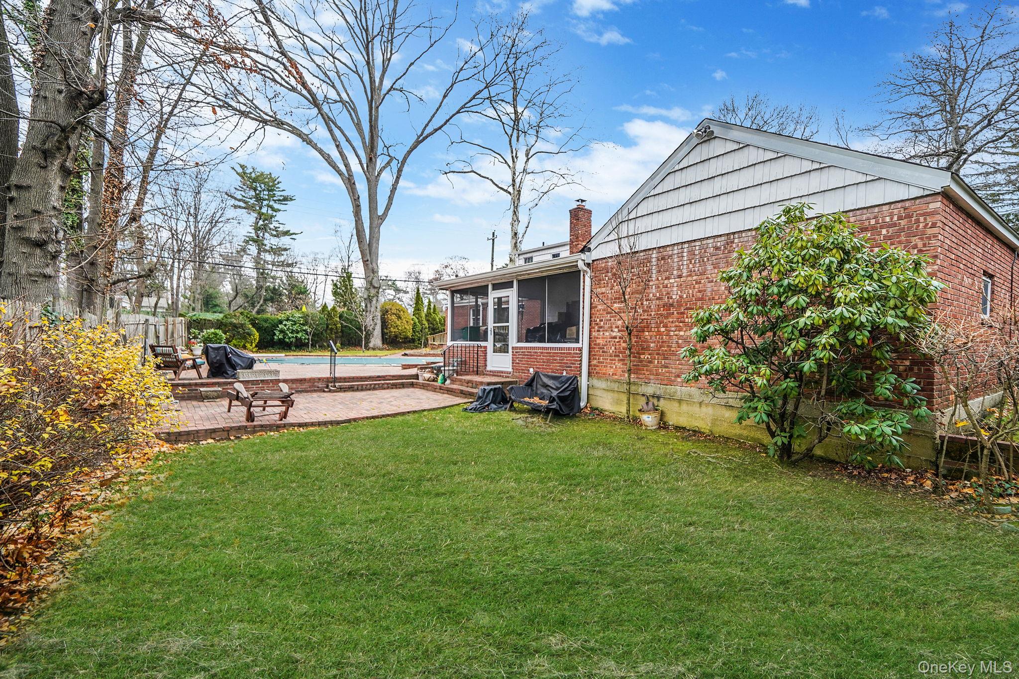 7 Rugby Road Westbury, NY 11590 - Photo 44 of 46 View of yard featuring a sunroom, a pool, and a patio area