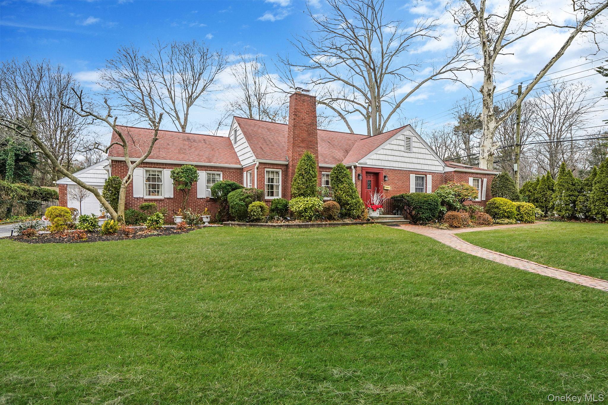 7 Rugby Road Westbury, NY 11590 - Photo 46 of 46 View of front facade with a front yard, a chimney, brick siding, and a shingled roof