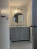 6691 Northwest 30th Street Sunrise, FL 33313 - Photo 19 of 26 a bathroom with a sink and a mirror