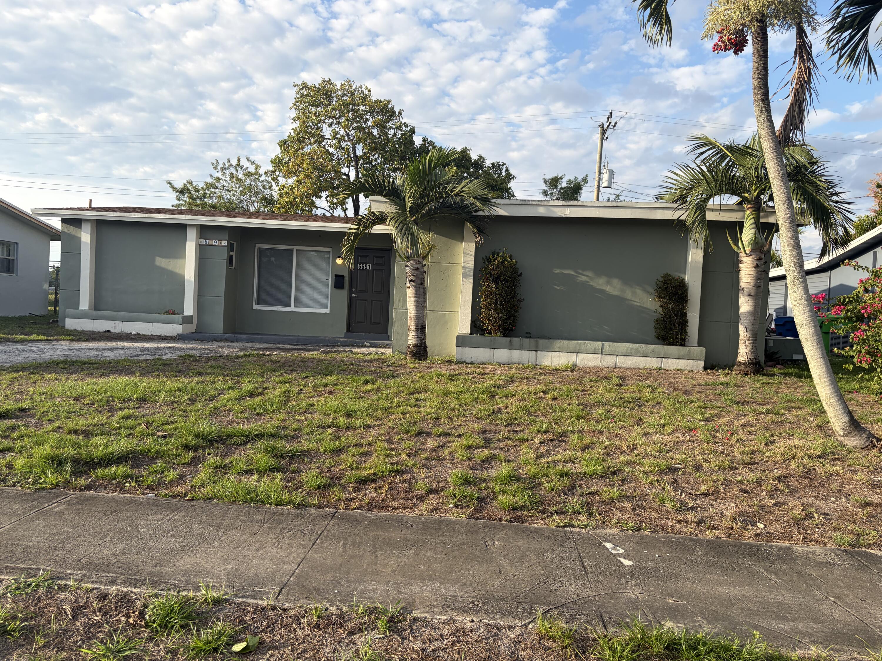 6691 Northwest 30th Street Sunrise, FL 33313 - Photo 2 of 26 a house with trees in the background