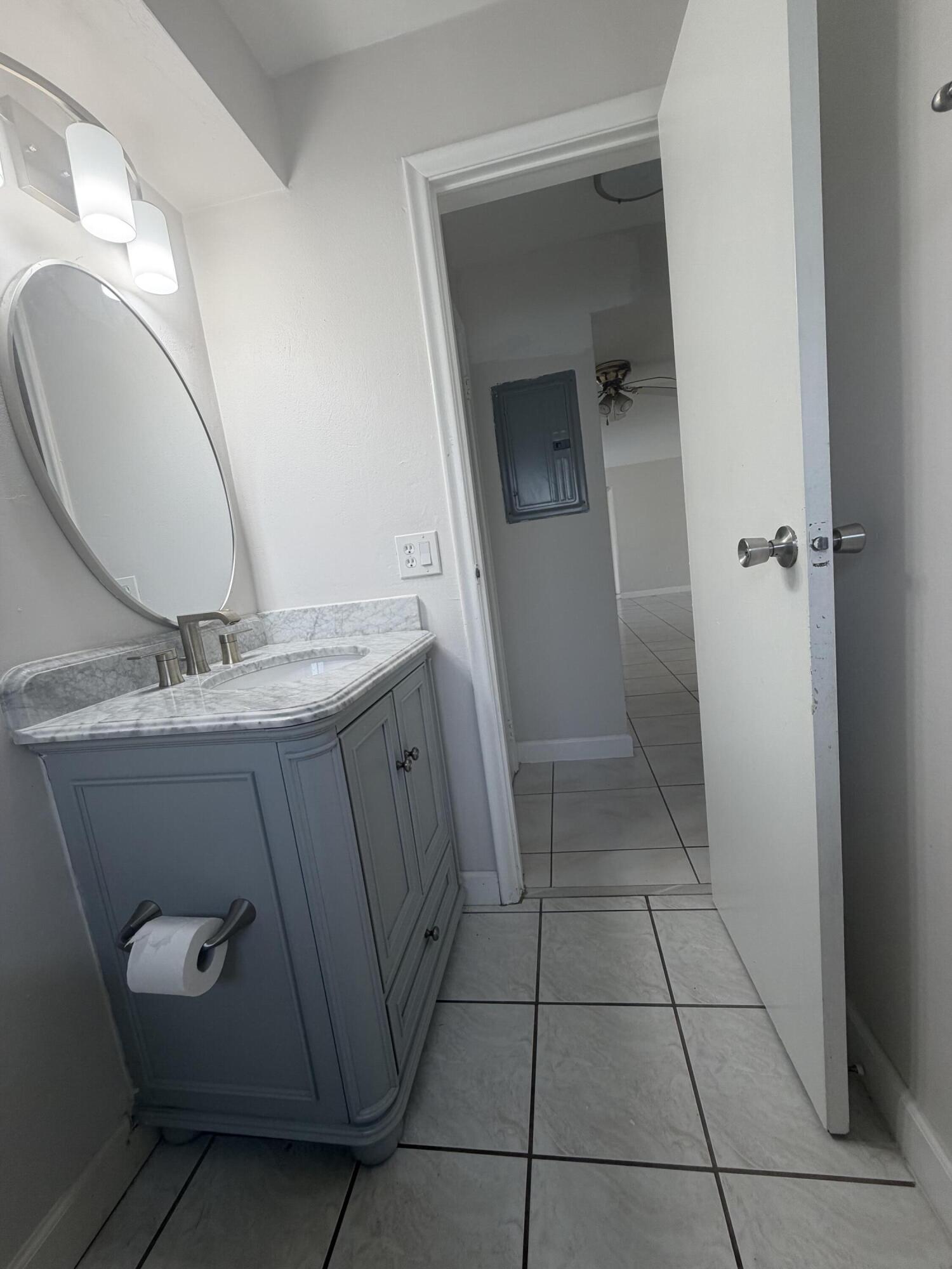 6691 Northwest 30th Street Sunrise, FL 33313 - Photo 24 of 26 a bathroom with a sink and mirror