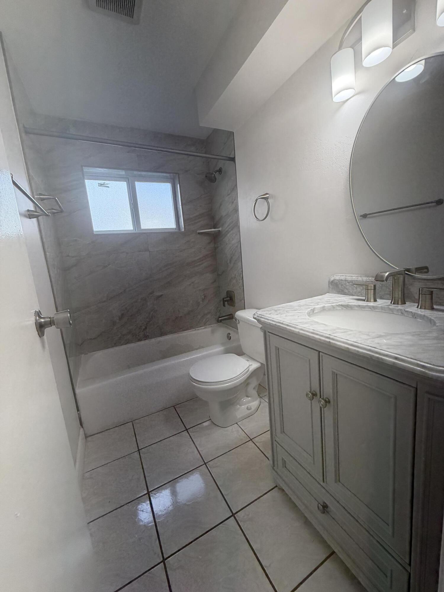 6691 Northwest 30th Street Sunrise, FL 33313 - Photo 25 of 26 a bathroom with a sink a toilet and shower
