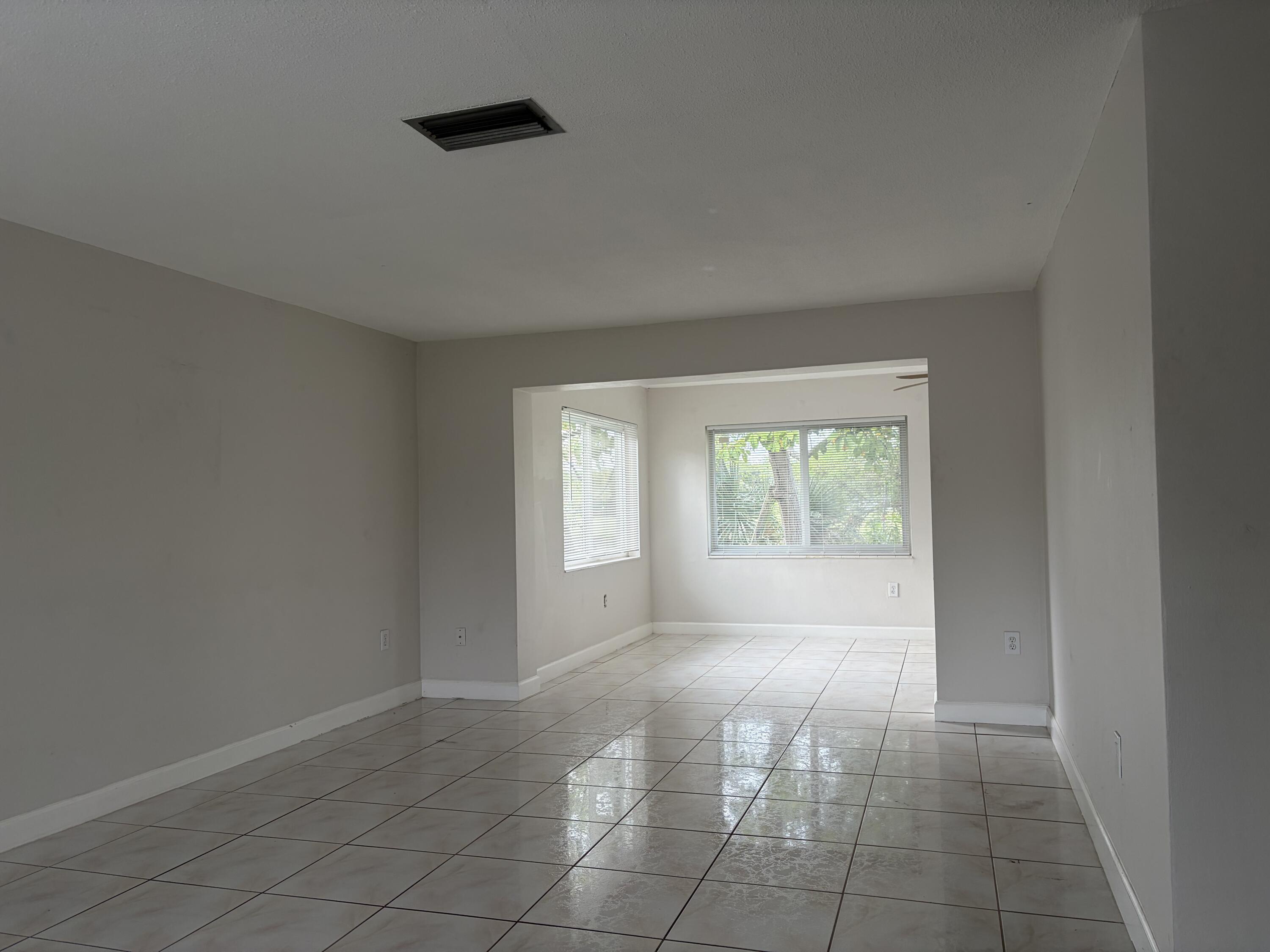 6691 Northwest 30th Street Sunrise, FL 33313 - Photo 6 of 26 an empty room with windows