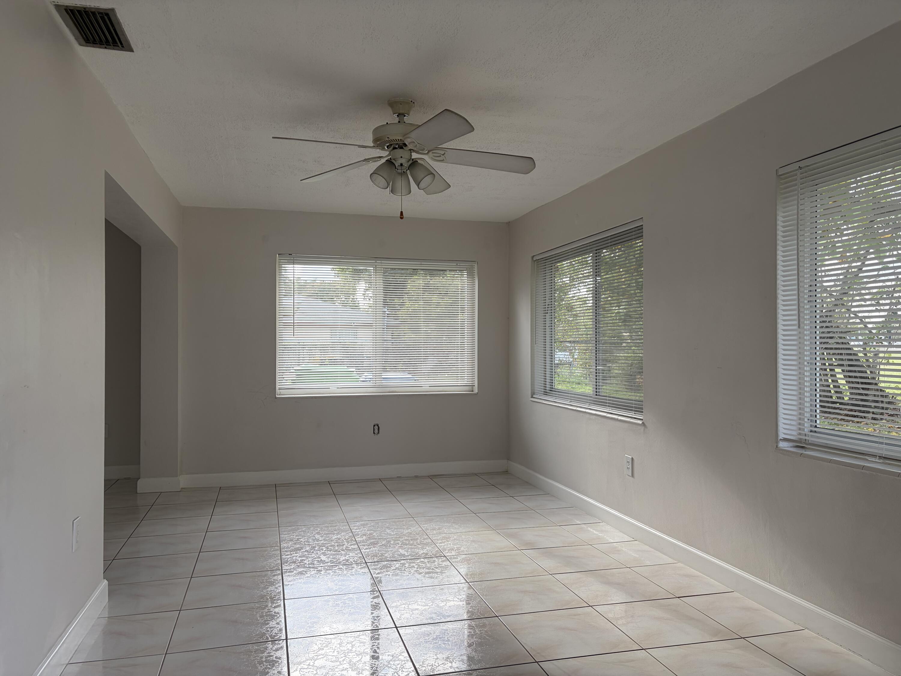6691 Northwest 30th Street Sunrise, FL 33313 - Photo 8 of 26 a view of room with a ceiling fan and window