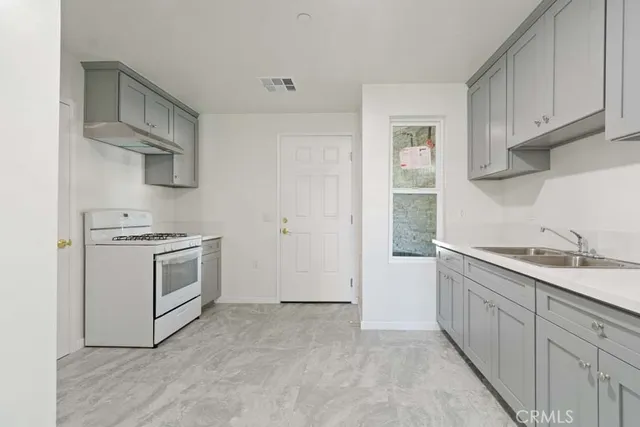 a kitchen with white cabinets