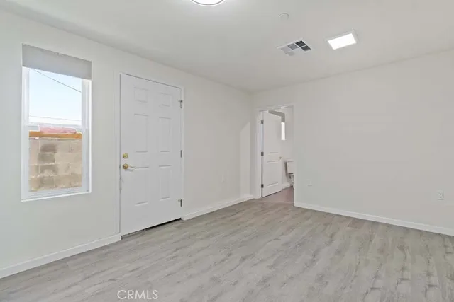 a view of kitchen with refrigerator and window