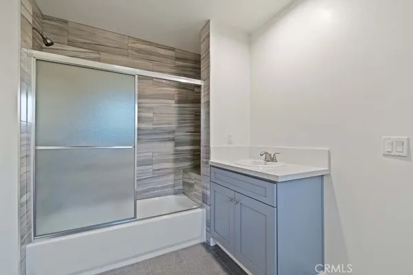 a view of a kitchen with a sink and a refrigerator