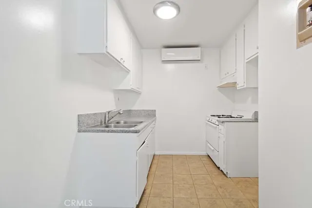 a bathroom with a granite countertop toilet sink and mirror