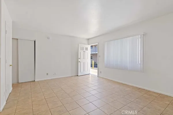 a view of a kitchen with white cabinets and a sink