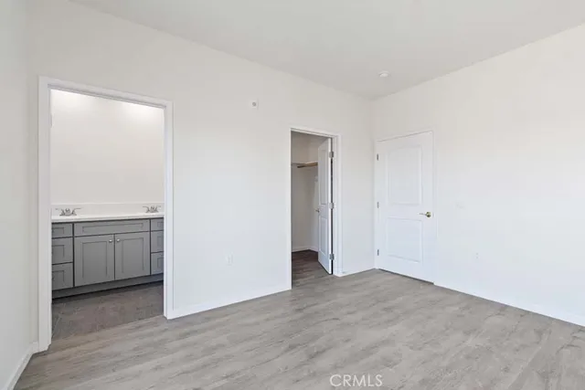 an empty room with wooden floor and a window