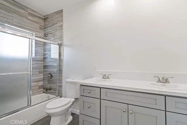 a view of a kitchen with wooden cabinet and a refrigerator