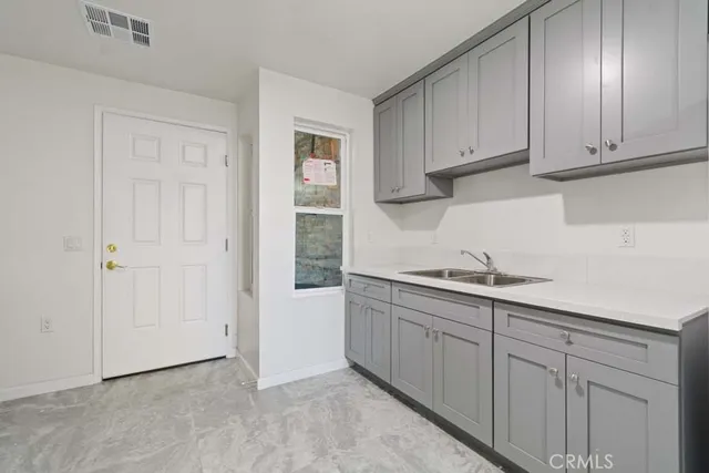 a kitchen with cabinets and stainless steel appliances