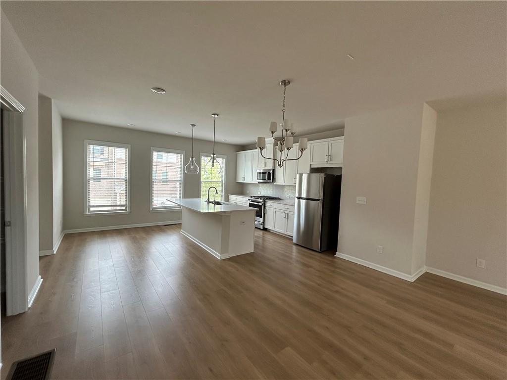 3715 Davis Circle Duluth, GA 30096 - Photo 7 of 20 a view of a kitchen with refrigerator and wooden floor