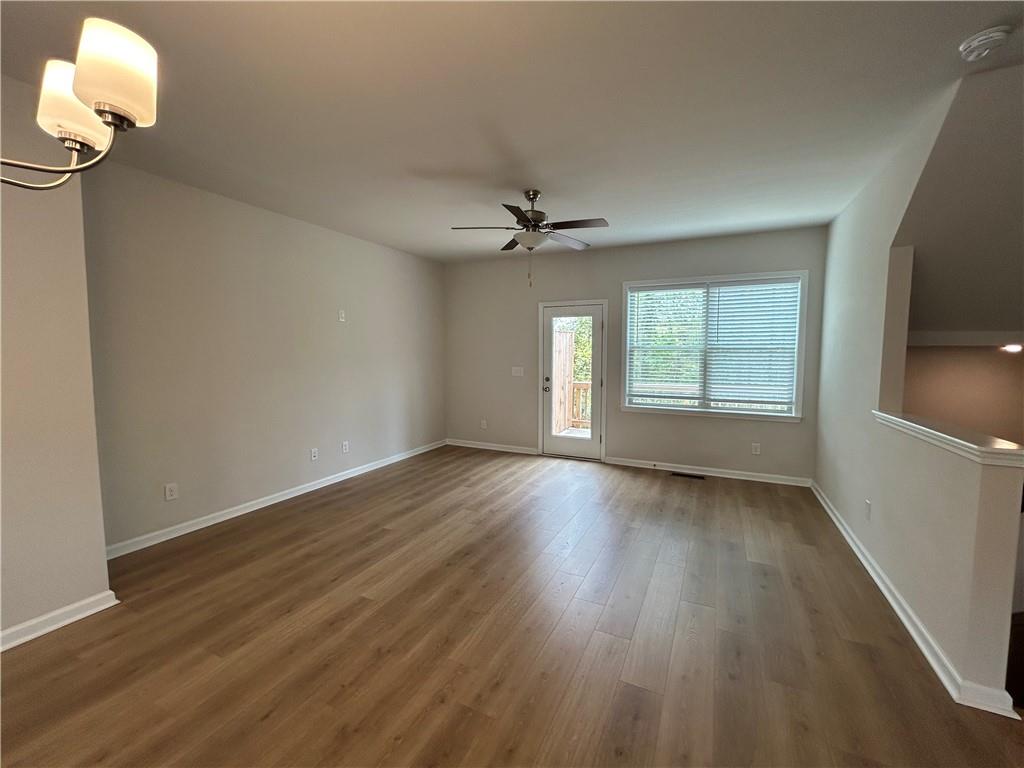 3715 Davis Circle Duluth, GA 30096 - Photo 8 of 20 an empty room with wooden floor fan and windows