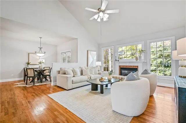 a living room with furniture a fireplace and a large window