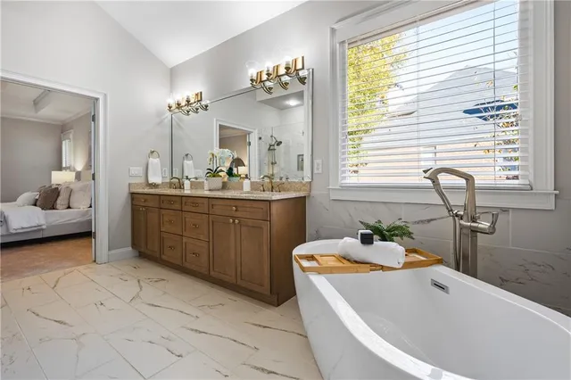 a bathroom with a tub sink and mirror