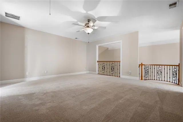 a view of a livingroom with a ceiling fan and window