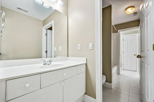a bathroom with a sink vanity granite tub and shower