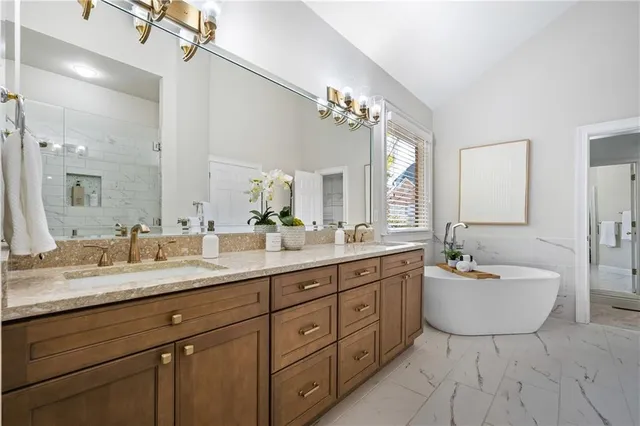 a spacious bathroom with a double vanity sink mirror and bathtub
