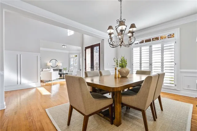 a view of a dining room with furniture wooden floor and chandelier