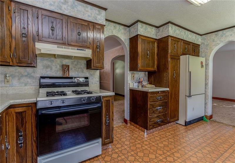 161 Highway 68 Rochester, PA 15074 - Photo 5 of 18 Kitchen has nice cabinetry and appliances stay. Leads to full dining room and living room areas.