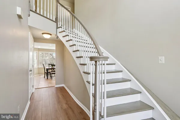 a dining room with furniture potted plants and wooden floor