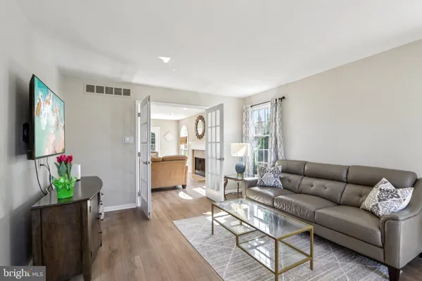 a dining room with a table chairs and a kitchen view