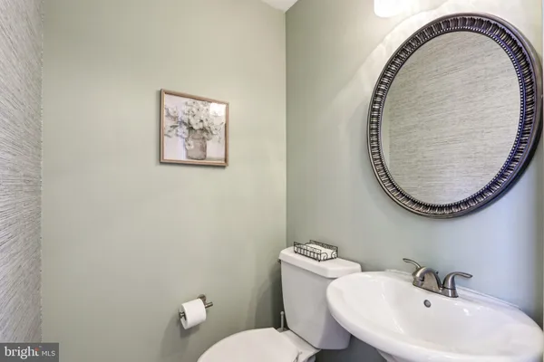 a en suite bathroom with a granite countertop sink and a mirror