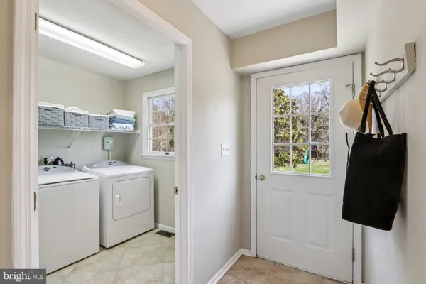 a bathroom with a granite countertop sink a toilet and a window