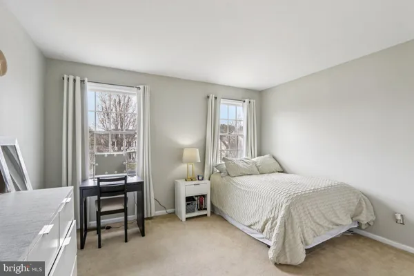 a view of a patio with a dining table and chairs under an umbrella
