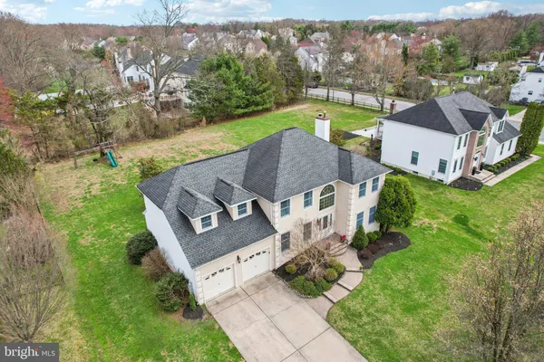 an aerial view of a house with garden space and street view