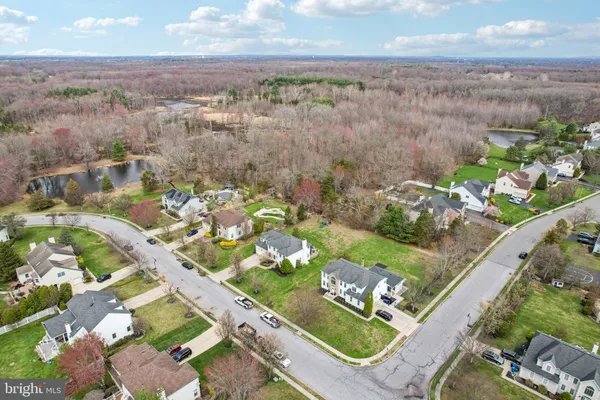 a view of a hallway with wooden floor staircase and windows