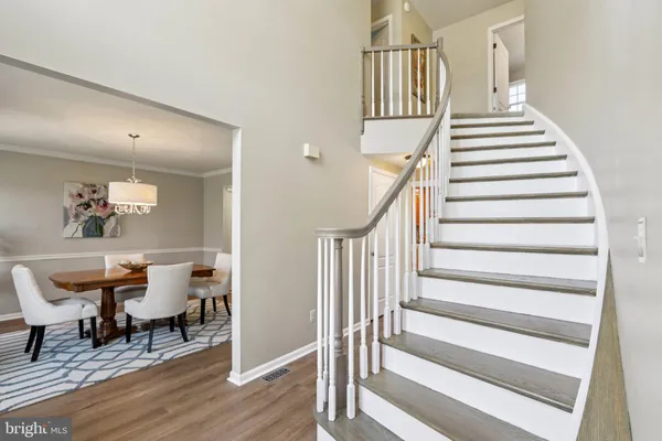 a view of a dining room with furniture and a chandelier