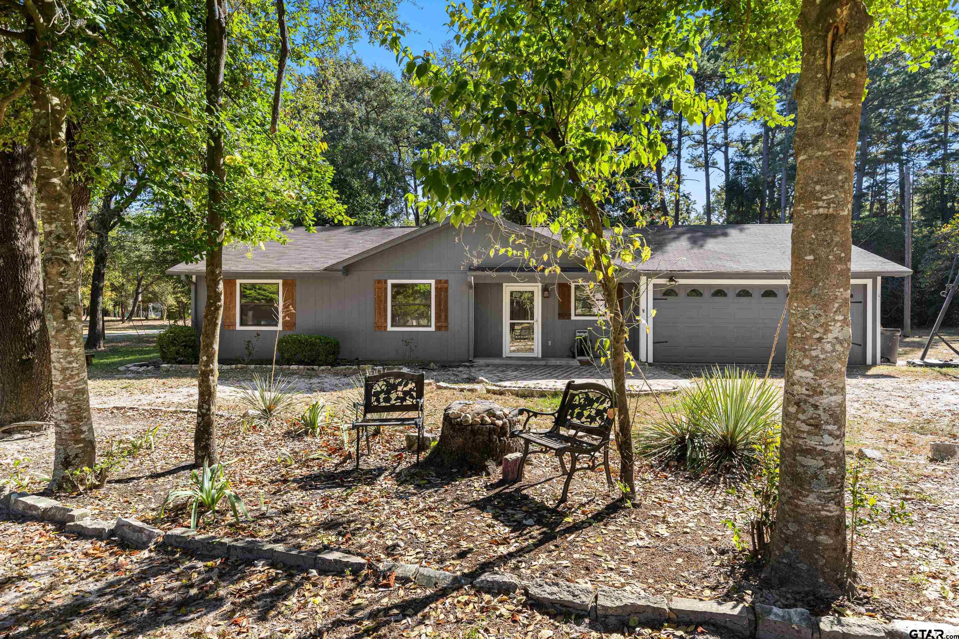 473 Meadow View Path Holly Lake Ranch, TX 75765 - Photo 11 of 37 a view of backyard of house with wooden deck and seating space