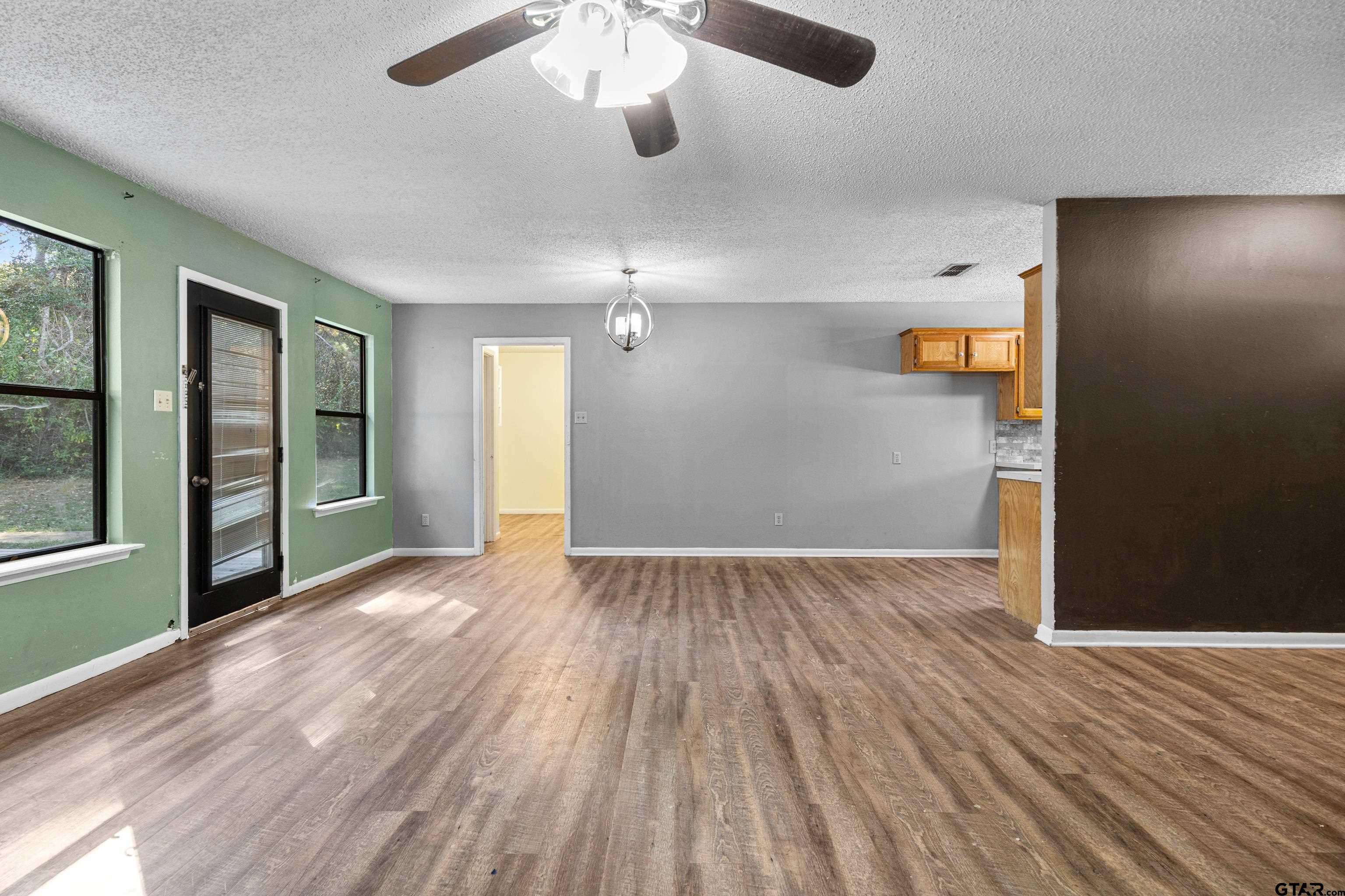 473 Meadow View Path Holly Lake Ranch, TX 75765 - Photo 13 of 37 wooden floor in an empty room with a window