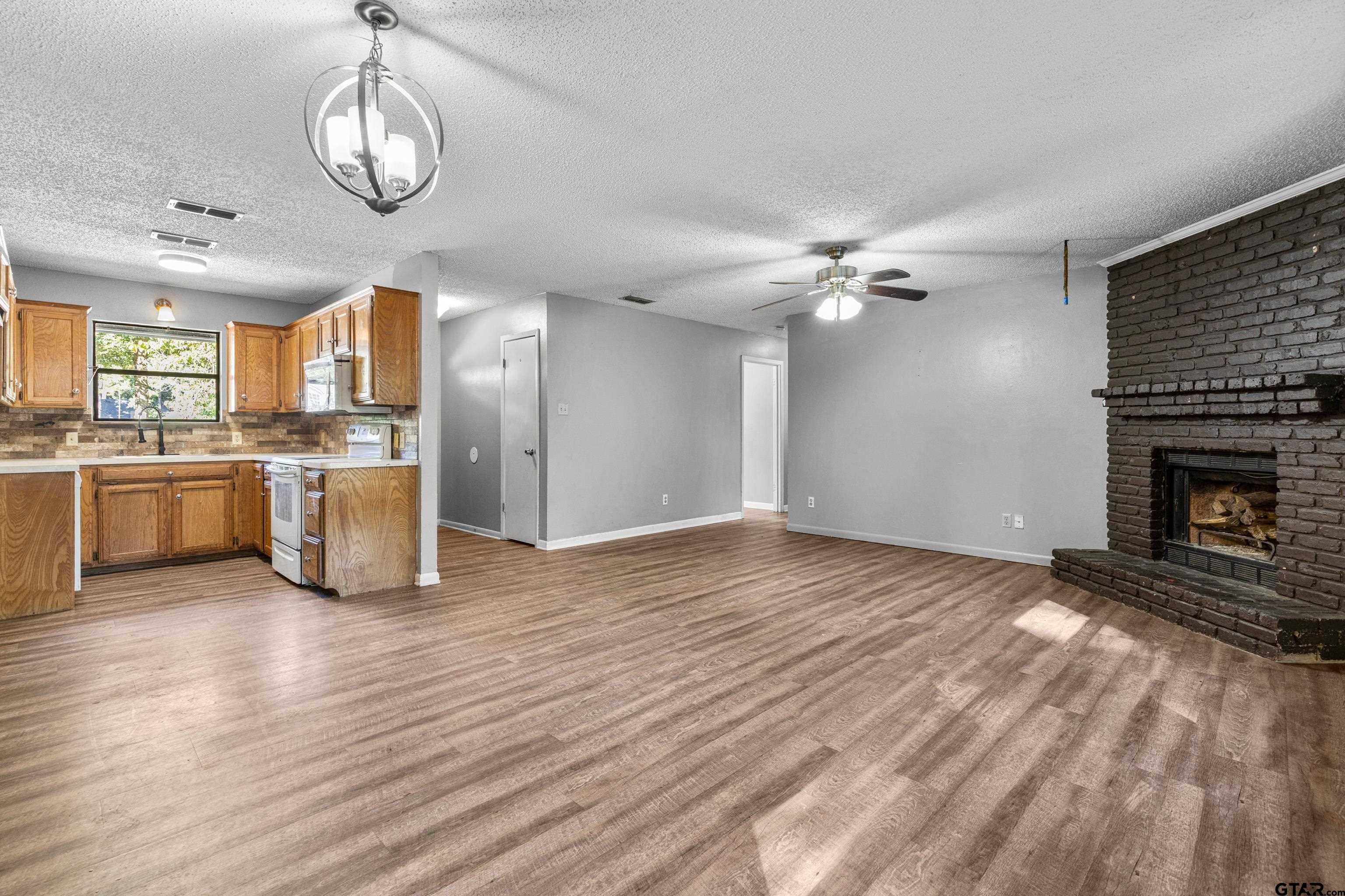 473 Meadow View Path Holly Lake Ranch, TX 75765 - Photo 16 of 37 a view of a kitchen with a stove cabinets and wooden floor