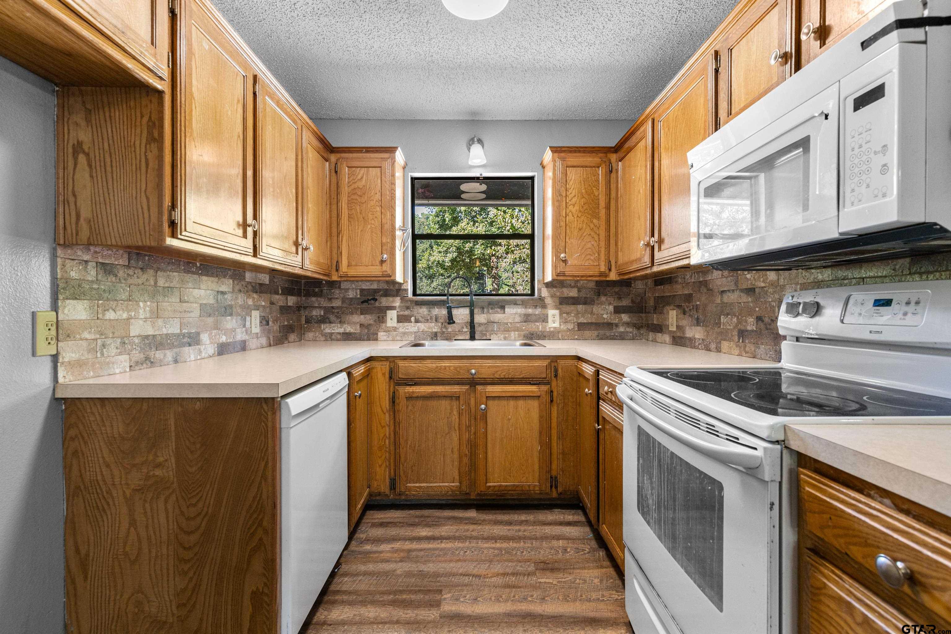 473 Meadow View Path Holly Lake Ranch, TX 75765 - Photo 17 of 37 a kitchen with stainless steel appliances granite countertop a sink stove and cabinets