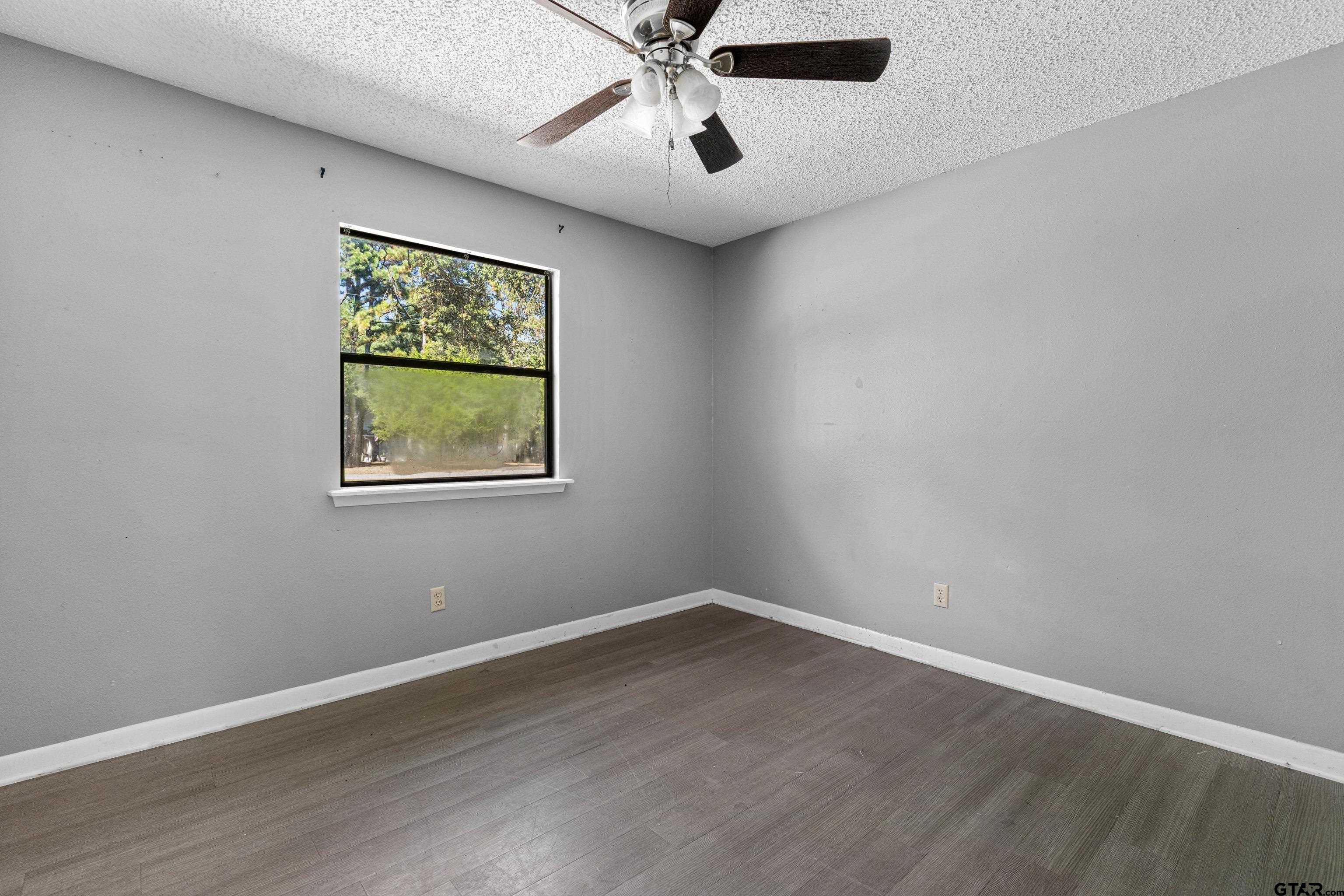 473 Meadow View Path Holly Lake Ranch, TX 75765 - Photo 26 of 37 a view of a big room with wooden floor and windows