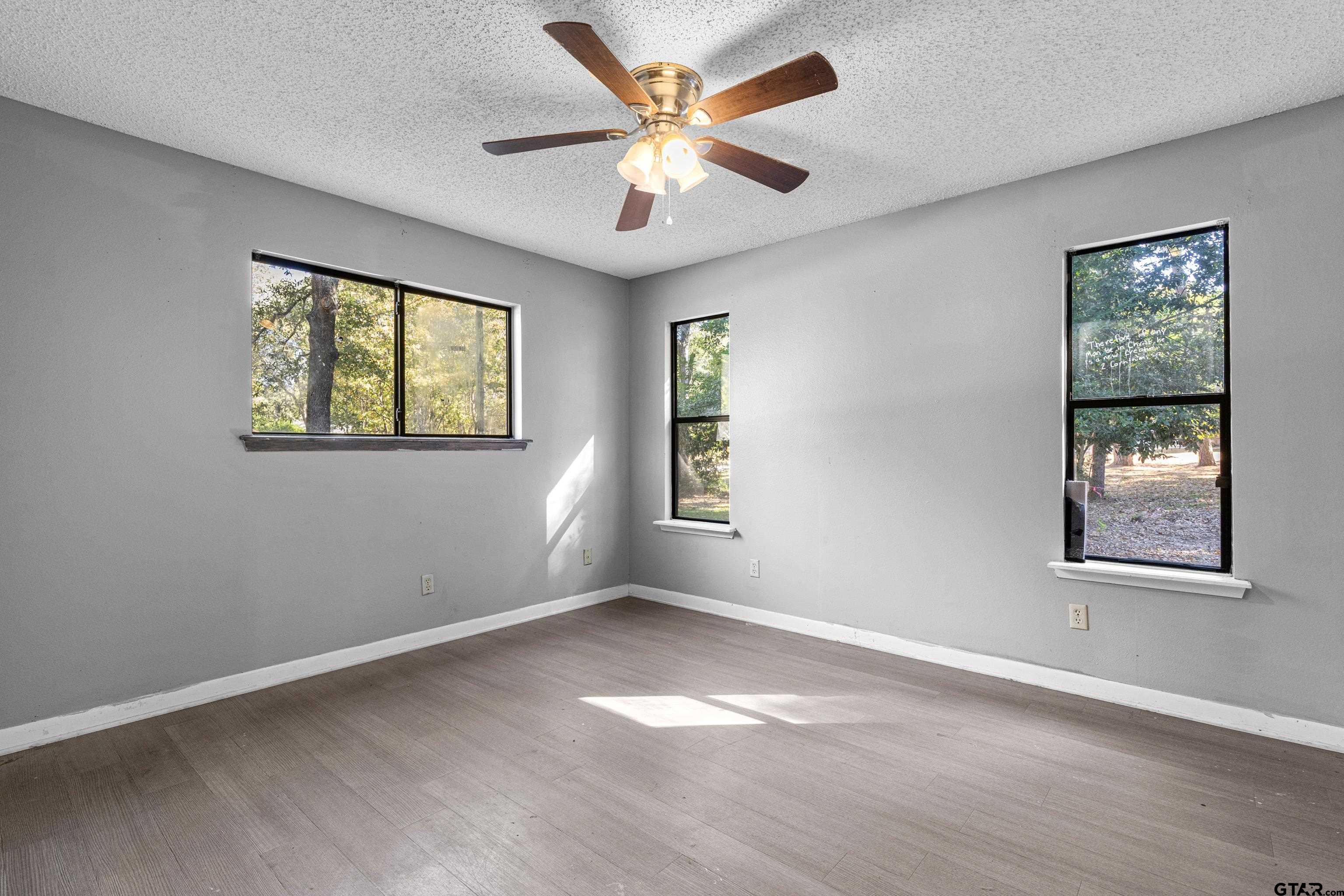 473 Meadow View Path Holly Lake Ranch, TX 75765 - Photo 28 of 37 a view of an empty room with window and wooden floor