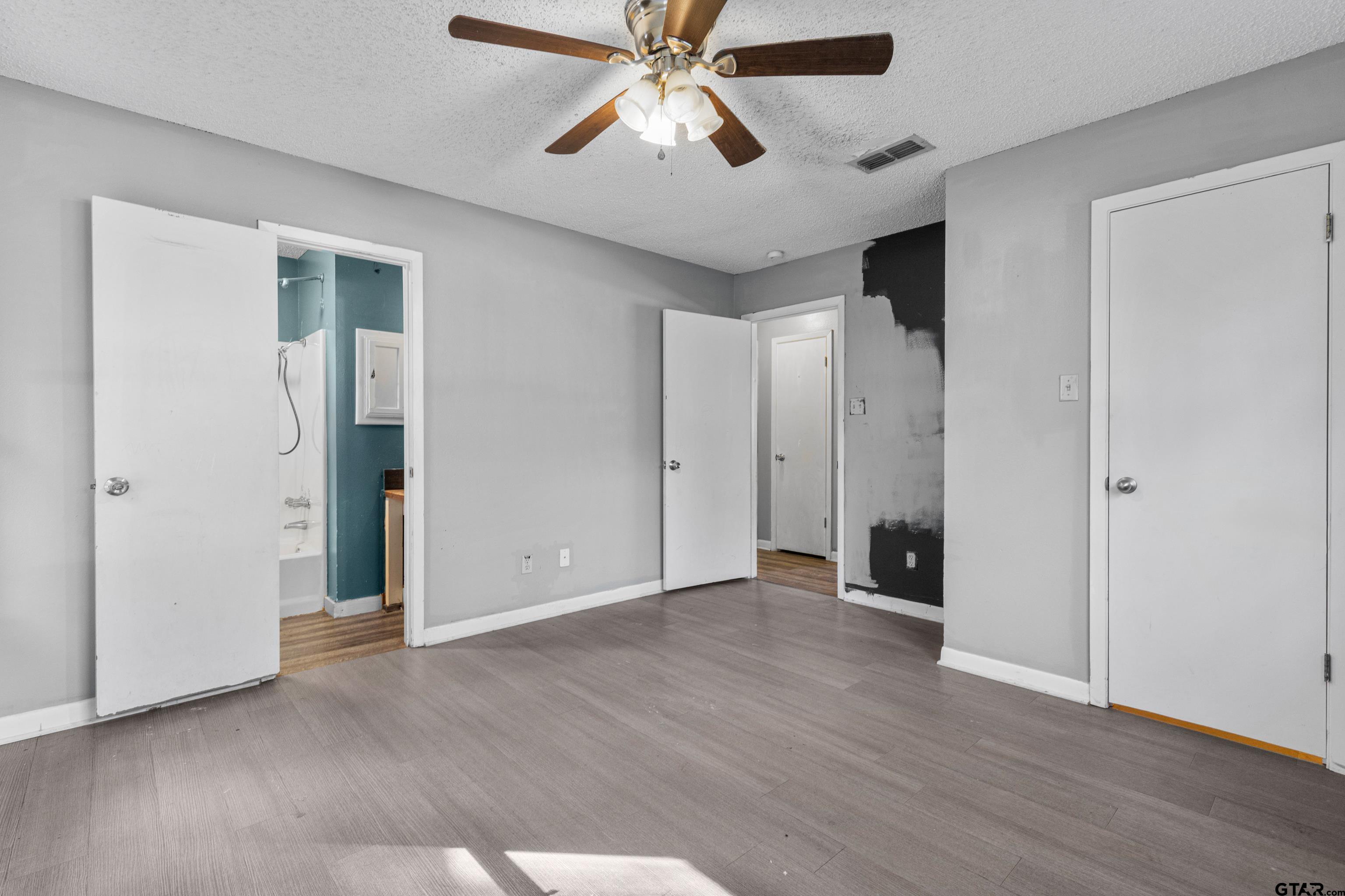 473 Meadow View Path Holly Lake Ranch, TX 75765 - Photo 29 of 37 wooden floor in an empty room with a chandelier fan