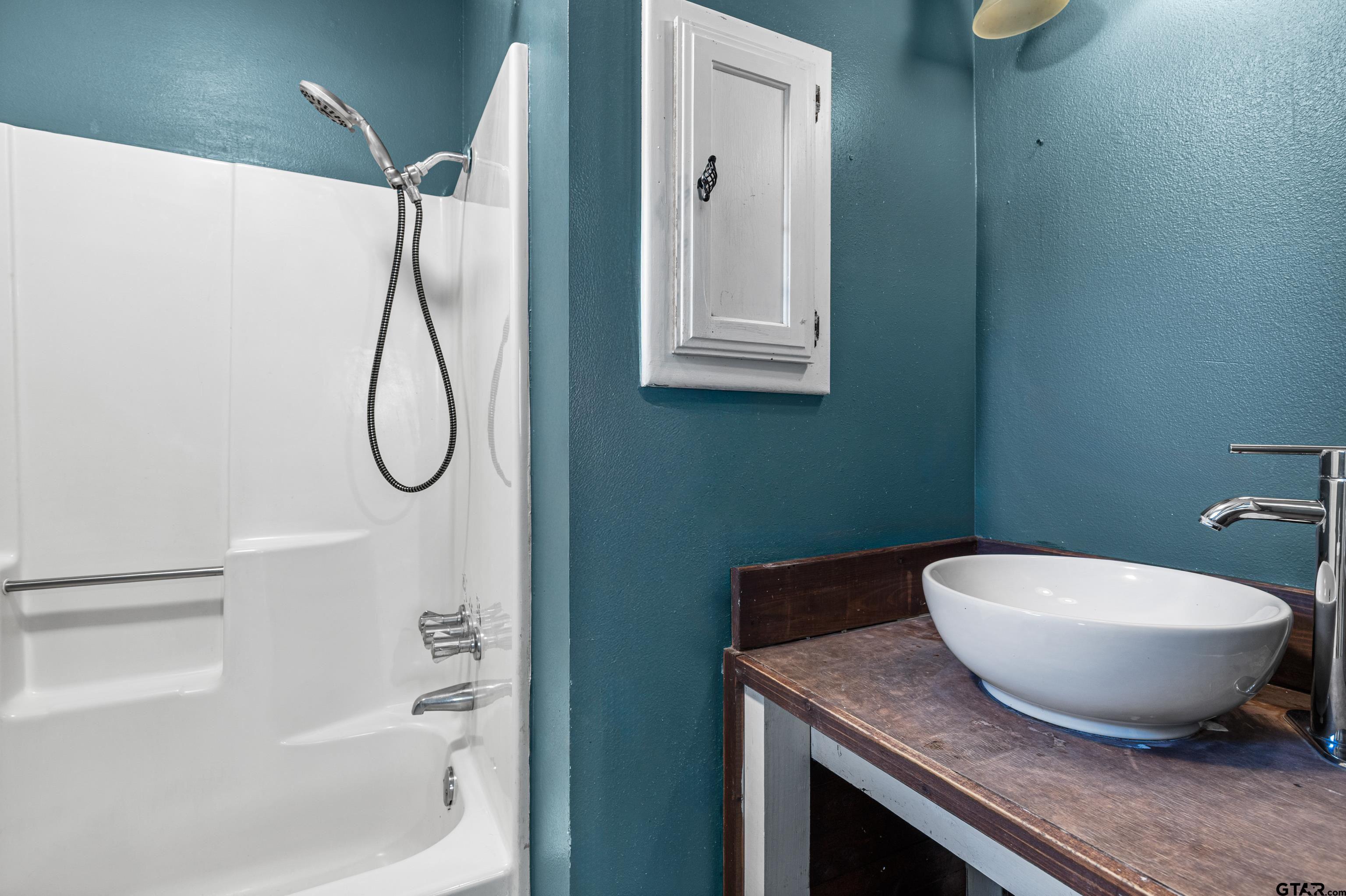 473 Meadow View Path Holly Lake Ranch, TX 75765 - Photo 31 of 37 a bathroom with a granite countertop sink a toilet and a bathtub