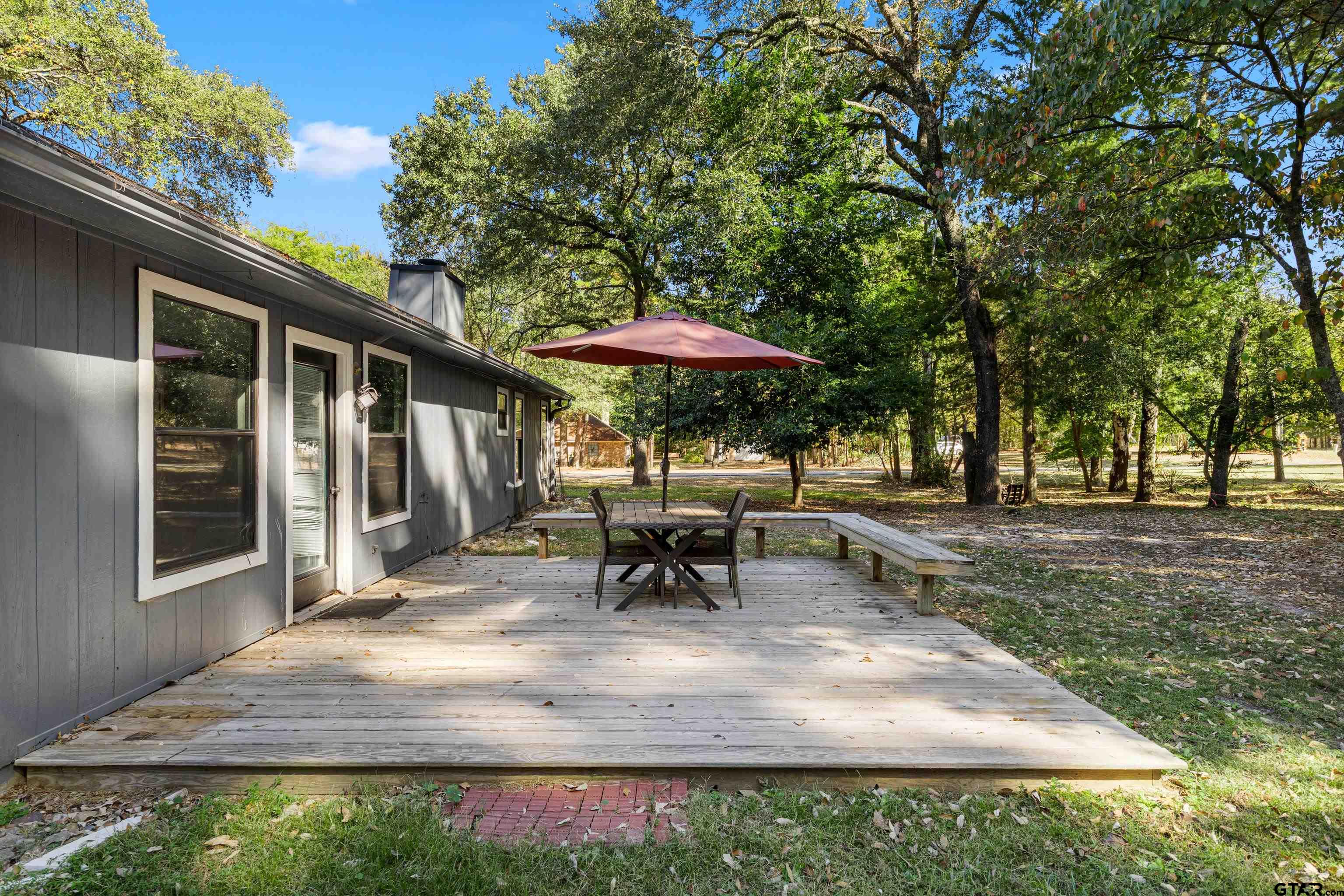 473 Meadow View Path Holly Lake Ranch, TX 75765 - Photo 32 of 37 a view of a house with backyard and sitting area