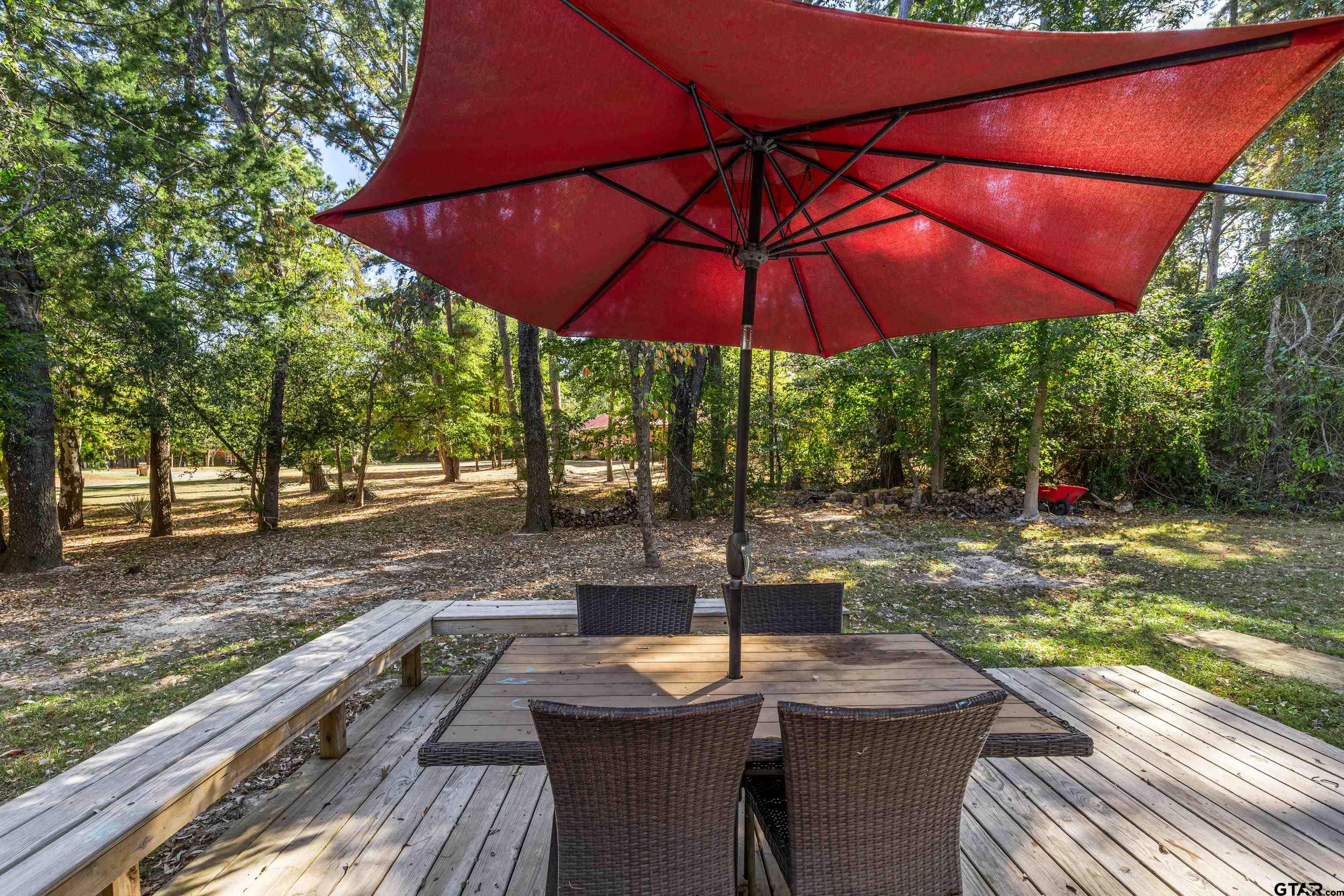 473 Meadow View Path Holly Lake Ranch, TX 75765 - Photo 33 of 37 a view of a patio with a table and chairs under an umbrella