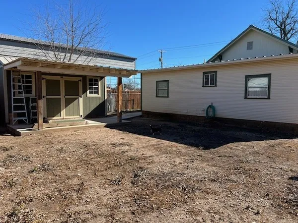a view of a house with wooden fence